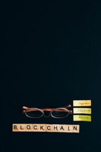 eyeglasses and scrabble tiles on a black surface